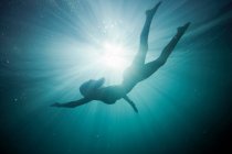 Silhouette of girl underwater — Stock Photo