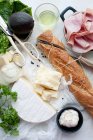 Bread, meat, cheese and oil on table — Stock Photo