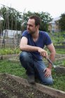 Man working in allotment — Stock Photo