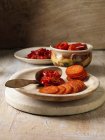 Pepperoni y chile en platos de madera - foto de stock