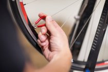 Person using spoke wrench on wheel — Stock Photo