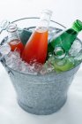 Bottles in bucket of ice — Stock Photo