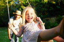 Father pushing his girl on the swing — Stock Photo