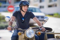 Young man riding a motorbike — Stock Photo