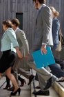 Business people walking down steps — Stock Photo