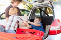 Father and sons unloading groceries, selective focus — Stock Photo