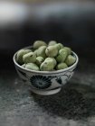 Bowl of wasabi peas — Stock Photo