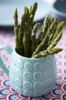 Asparagus tips in mug — Stock Photo