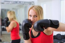 Boxer training with gloves in gym — Stock Photo
