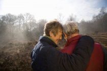 Retired Couple Hugging outdoors — Stock Photo
