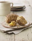 Mixed seed bread roll with butter — Stock Photo