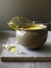 Saffron aioli in bowl with whisk — Stock Photo