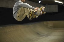 Молодой человек делает скейтборд трюк — стоковое фото