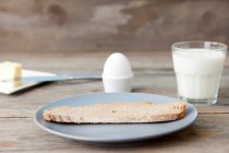 Bread and egg with glass of milk — Stock Photo