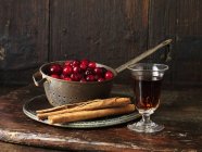 Cranberries, sherry, and cinnamon sticks — Stock Photo