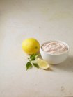 Taramasalata dip in bowl with lemons — Stock Photo