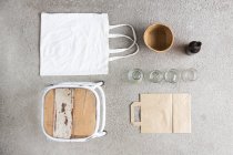 Overhead still life of stool, reusable shopping bag and recyclable paper and bottles — Stock Photo
