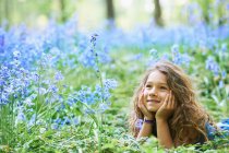 Girl laying in field of flowers — Stock Photo