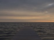 Seascape with pier at sunrise — Stock Photo