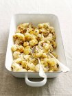 Roasted cauliflower with spoons in pot — Stock Photo