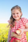 Menina comendo saco de maçãs ao ar livre — Fotografia de Stock