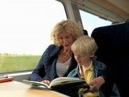 Grandmother and grandson reading book — Stock Photo