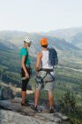 Climbers overlooking rural valley — Stock Photo