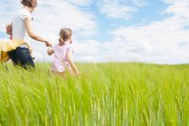 Mother with two daughters in field — Stock Photo