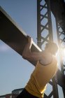 Man doing chin ups on bridge, Munich, Bavaria, Germany — Stock Photo