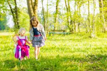 Girls walking together in field — Stock Photo