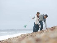 Vater und Sohn kämmen Strand — Stockfoto