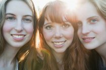 Portrait of three smiling teenage girls — Stock Photo