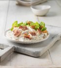 Chicken with bacon and caesar salad — Stock Photo