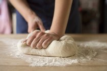 Human hands kneading bread dough — Stock Photo