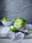 Iceberg lettuce on white tea towel — Stock Photo