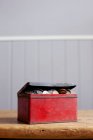 Antique tin full of money on desk — Stock Photo