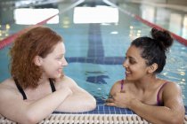Женщины разговаривают в закрытом бассейне — стоковое фото