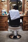 Barbers char with towel, rear view — Stock Photo