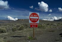 Do not enter sign in rural landscape with cloudy sky — Stock Photo