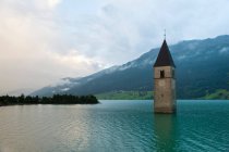 Clock tower submerged in lake — Stock Photo