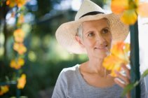 Woman wearing straw hat outdoors — Stock Photo