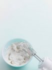Electric mixer in bowl of frosting — Stock Photo