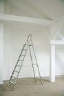 Metal ladder in empty house — Stock Photo