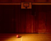 Quadra de basquete vazia com bola no chão — Fotografia de Stock