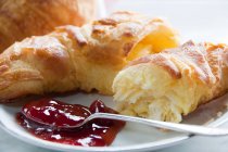 Croissants and jam on plate — Stock Photo