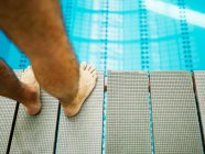 Man standing on diving board close-up — Stock Photo