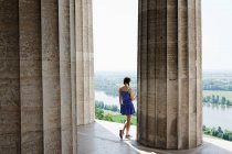 Woman by stone columns, Regensburg, Bavaria, Germany — Stock Photo