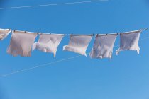 T-shirts waving on clothes line — Stock Photo