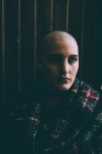 Low key portrait of young woman with shaved head — Stock Photo