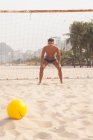 Goalkeeper in defence position on beach — Stock Photo